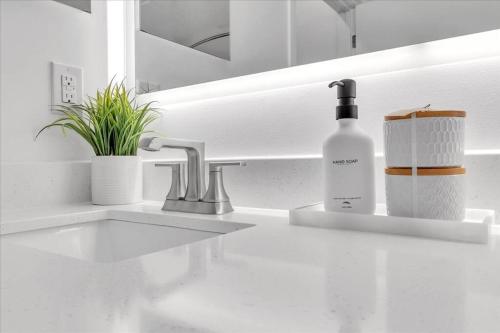 a white kitchen counter with a bottle of soap and a sink at Dream Stay Near Crystal Bridges Museum & Amazeum in Bentonville