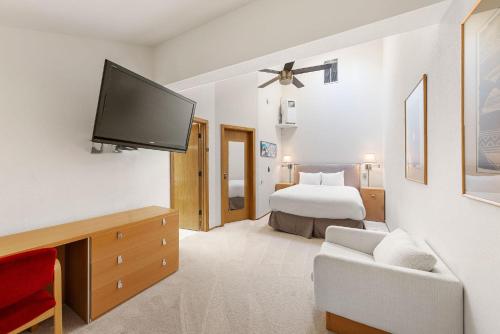 a bedroom with a bed and a flat screen tv at Palisades Tahoe Lodge Rentals Studio Loft #308 in Olympic Valley