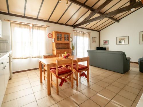 a kitchen and dining room with a table and a couch at Holiday Home zeewind by Interhome in Bredene