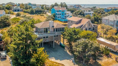 an aerial view of a large house with trees at Duck N Cover in Duck