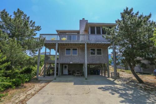 a large house with a balcony on top of it at Duck N Cover in Duck