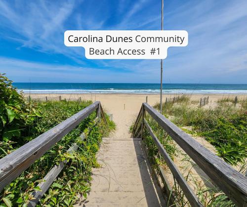 a path to the beach with a sign that reads carolina dunes community beach at Duck N Cover in Duck