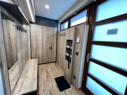 a sauna with wooden walls and a glass door at Holiday Home Říčky F38 by Interhome in Říčky