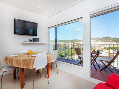 a dining room with a table and a large window at Apartment Cortijo Barques by Interhome in Sitges