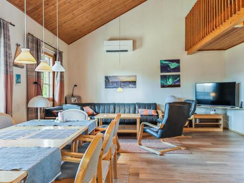 a living room with a table and a couch at Holiday Home Teerenpesue e 37 by Interhome in Saariselka