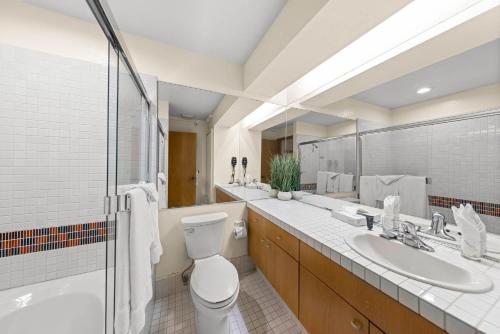 a bathroom with a toilet and a sink and a shower at Palisades Tahoe Lodge Rentals Studio Loft #315 in Olympic Valley