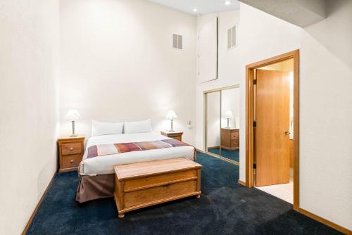 a hotel room with a bed and a door at Palisades Tahoe Lodge Rentals Studio Loft #315 in Olympic Valley