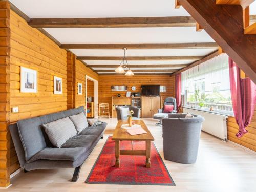 a living room with a couch and a table at Holiday Home Am Hohen Bogen-74 by Interhome in Kummersdorf