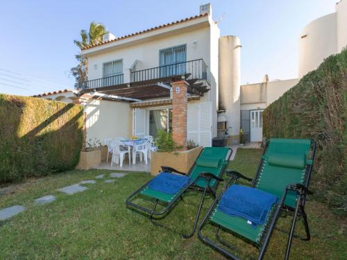 a group of chairs in the yard of a house at Villa Tres calas 2 by Interhome in L'Ametlla de Mar