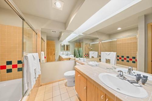 a bathroom with a sink and a tub and a toilet at Palisades Tahoe Lodge Rentals Studio Loft #345 in Olympic Valley
