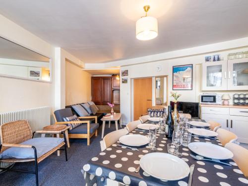 a dining room with tables and chairs and a room at Apartment Les Hauts du Val Claret - Val Claret-24 by Interhome in Tignes