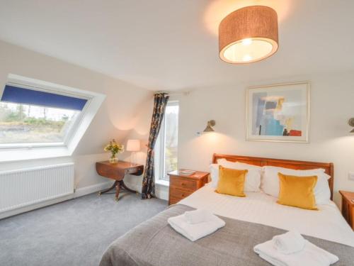 a bedroom with a bed and a window at Holiday Home Blackmount House by Interhome in Oban