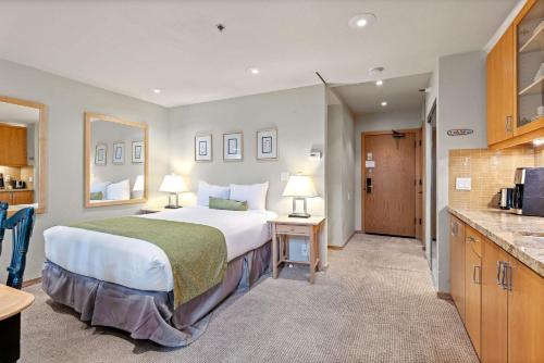 a hotel room with a large bed and a kitchen at Studio Loft #349 in Olympic Valley