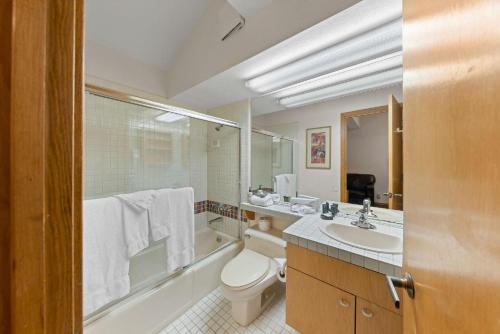 a bathroom with a toilet and a sink at Palisades Tahoe Lodge Rentals Studio Loft #314 in Olympic Valley