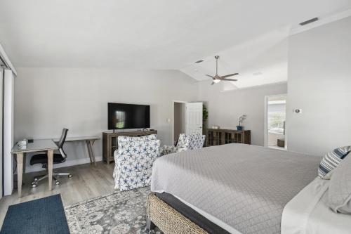 a bedroom with a bed and a desk with a computer at Lake House Westchase area. Heated Pool Waterfront! in Tampa