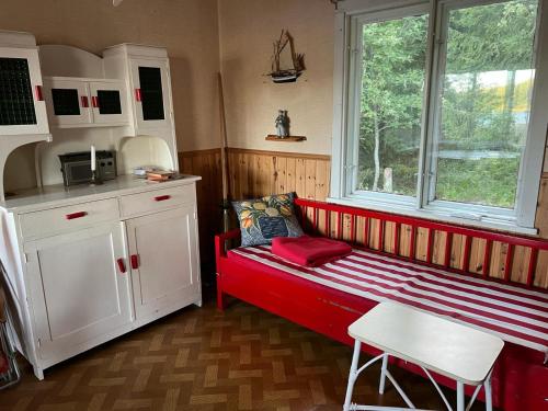 a kitchen with a red bench in a room at Summer House with Sauna on Beautiful Island 