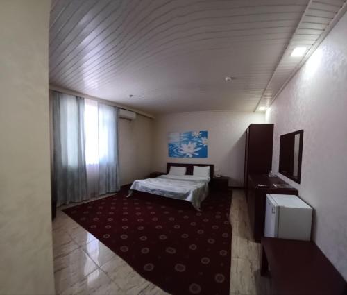 a bedroom with a bed and a large rug at Gabala Bliss Inn Hotel and Restaurant in Gabala