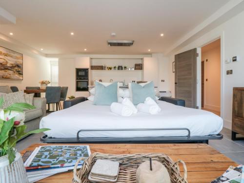 a bedroom with a large bed with blue pillows at 31 Cliff Edge in Newquay