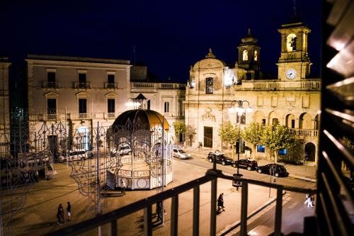 a view of a city at night with a building at B&B Casa Ninè in Gioia del Colle
