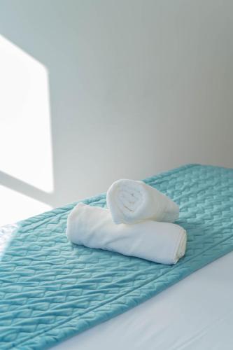 two rolled towels sitting on top of a bed at Apartamentos Granata in Granada