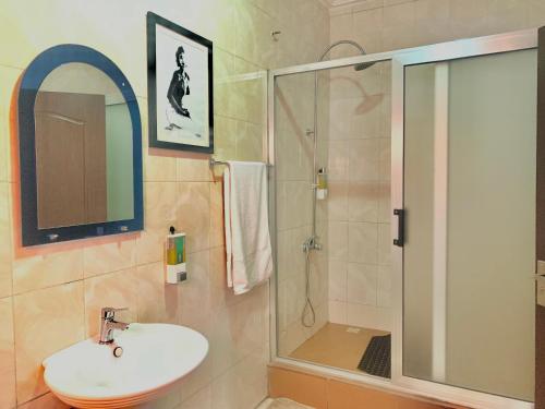 a bathroom with a sink and a shower at Royals 2 bedrooms Luxury in Accra