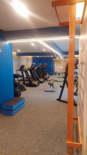 a gym with rows of treadmills and pilates equipment at Park Hotel in Recife