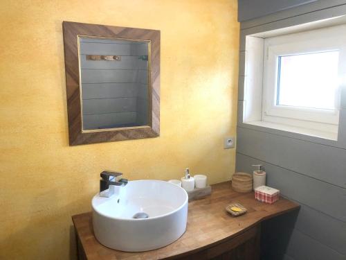 a bathroom with a white sink and a mirror at Maison de 6 chambres avec jardin amenage et wifi a Sainte Croix aux Mines in Sainte-Croix-aux-Mines