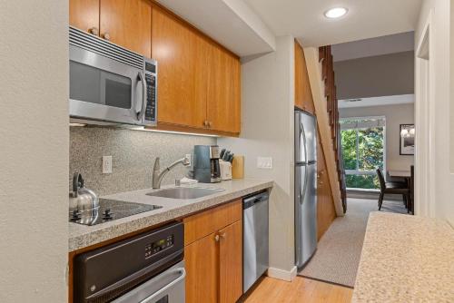 a kitchen with a sink and a microwave at Palisades Tahoe Lodge Rentals Premium Studio Loft #313 in Olympic Valley