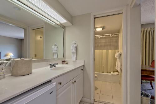 a bathroom with a sink and a mirror and a shower at Kingwood Resort & Winery in Clayton