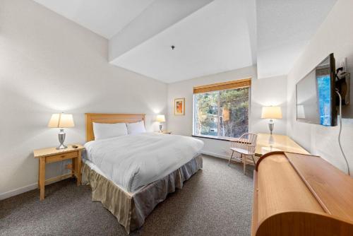a bedroom with a large bed and a window at Two Bedroom #521 in Olympic Valley