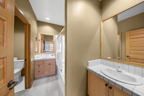 a bathroom with a sink and a mirror at Palisades Tahoe Lodge Rentals Two Bedroom #804 in Olympic Valley
