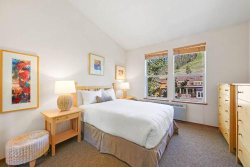 a bedroom with a large bed and a window at Palisades Tahoe Lodge Rentals Two Bedroom #814 in Olympic Valley