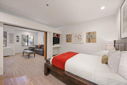 a bedroom with a large bed and a living room at Palisades Tahoe Lodge Rentals Premium Studio #252 in Olympic Valley