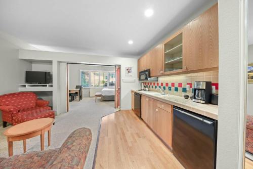 a kitchen with a living room and a dining room at Palisades Tahoe Lodge Rentals Studio #156 in Olympic Valley