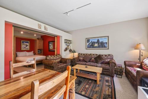 a living room with a couch and a bed at Studio #151 in Olympic Valley