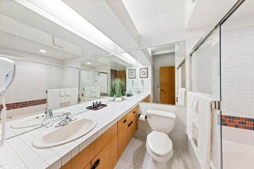 a white bathroom with a toilet and a sink at Studio #207 in Olympic Valley