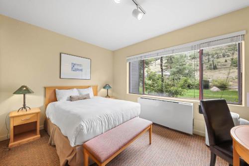a bedroom with a bed and a large window at Studio #155 in Olympic Valley