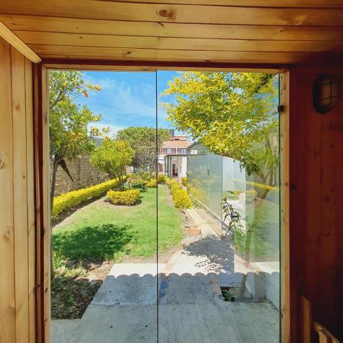 an open door with a view of a yard at La Huerta Hotel Boutique in Tibasosa