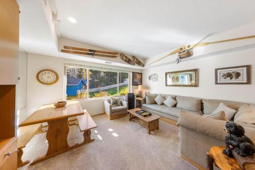 a living room with a couch and a table at Palisades Tahoe Lodge Rentals Studio #214 in Olympic Valley