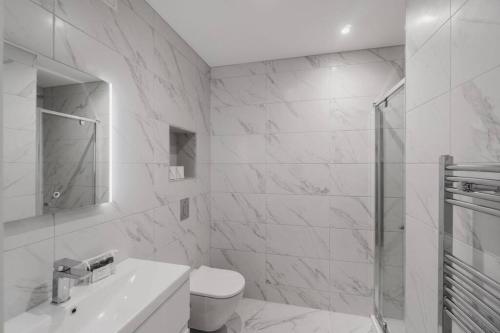 a white bathroom with a sink and a shower at 2BED/2BATH Bliss, Private Parking in Windsor