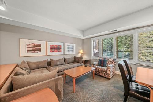 a living room with a couch and a table at Palisades Tahoe Lodge Rentals Studio #226 in Olympic Valley