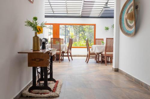 a dining room with a table and chairs at La Huerta Hotel Boutique in Tibasosa