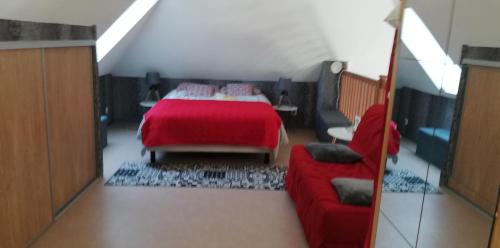 a bedroom with a red bed and a red couch at Vielle Aure Le 2 Bers 90m2 in Vielle-Aure