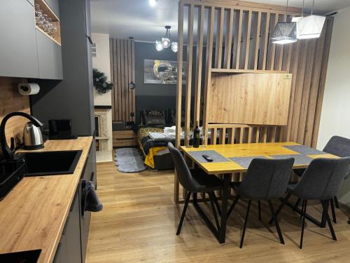 a kitchen and dining room with a table and chairs at Avelov Art Studio in Pamporovo