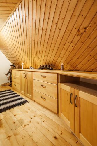 a room with wooden cabinets and a wooden ceiling at Chaloupka u Káji in Vítkovice