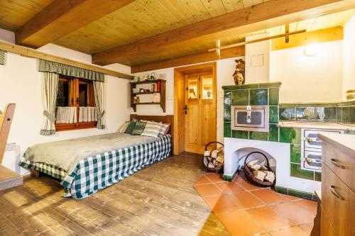 a bedroom with a bed in a room with wooden ceilings at Chaloupka u Káji in Vítkovice