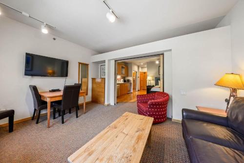 a living room with a couch and a table at Palisades Tahoe Lodge Rentals Studio #246 in Olympic Valley