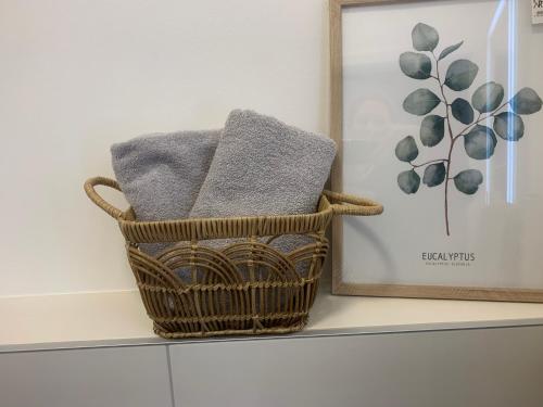 a basket with towels on a shelf next to a picture at Gästehaus Reichmann in Beverungen
