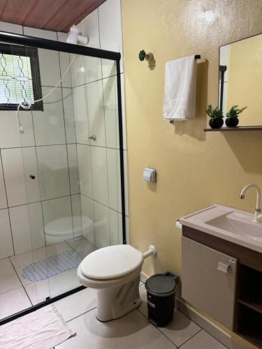 a bathroom with a shower and a toilet and a sink at Recanto da Serra in Pardinho