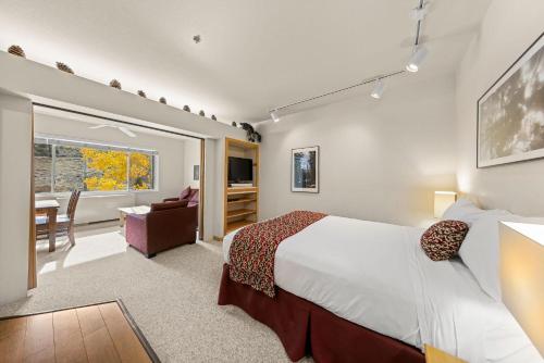 a bedroom with a large bed and a living room at Studio #253 in Olympic Valley
